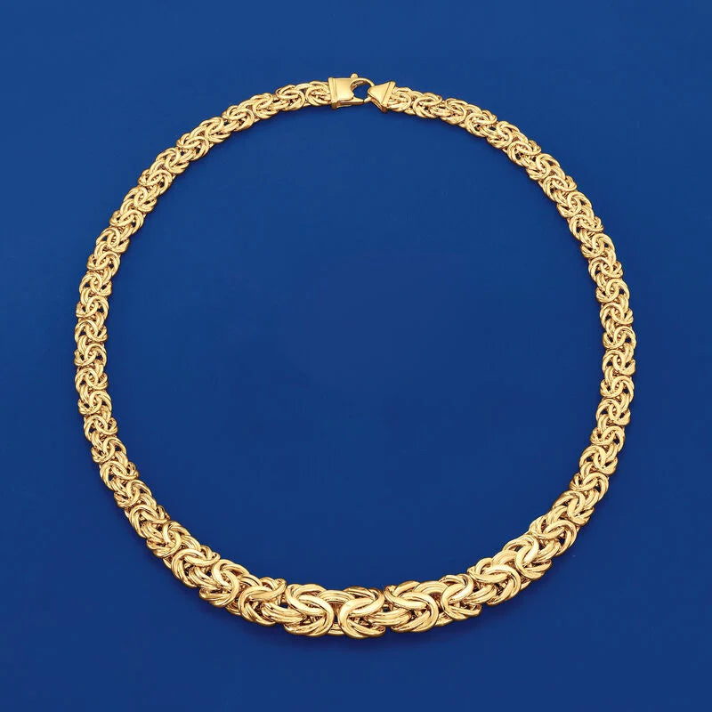 Gold necklace on a blue background available on the TX.ORO website.