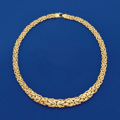 Gold necklace on a blue background available on the TX.ORO website.