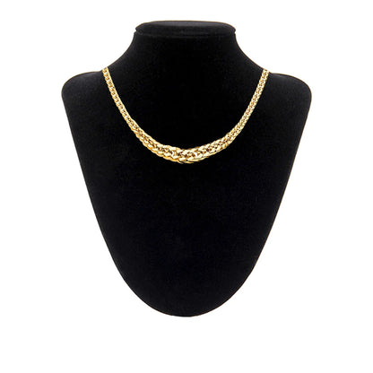 Gold chain necklace on a black mannequin bust against a white background available on the TX.ORO website.