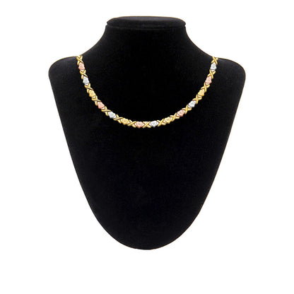 Gold necklace on a black mannequin bust against a white background available on the TX.ORO website.