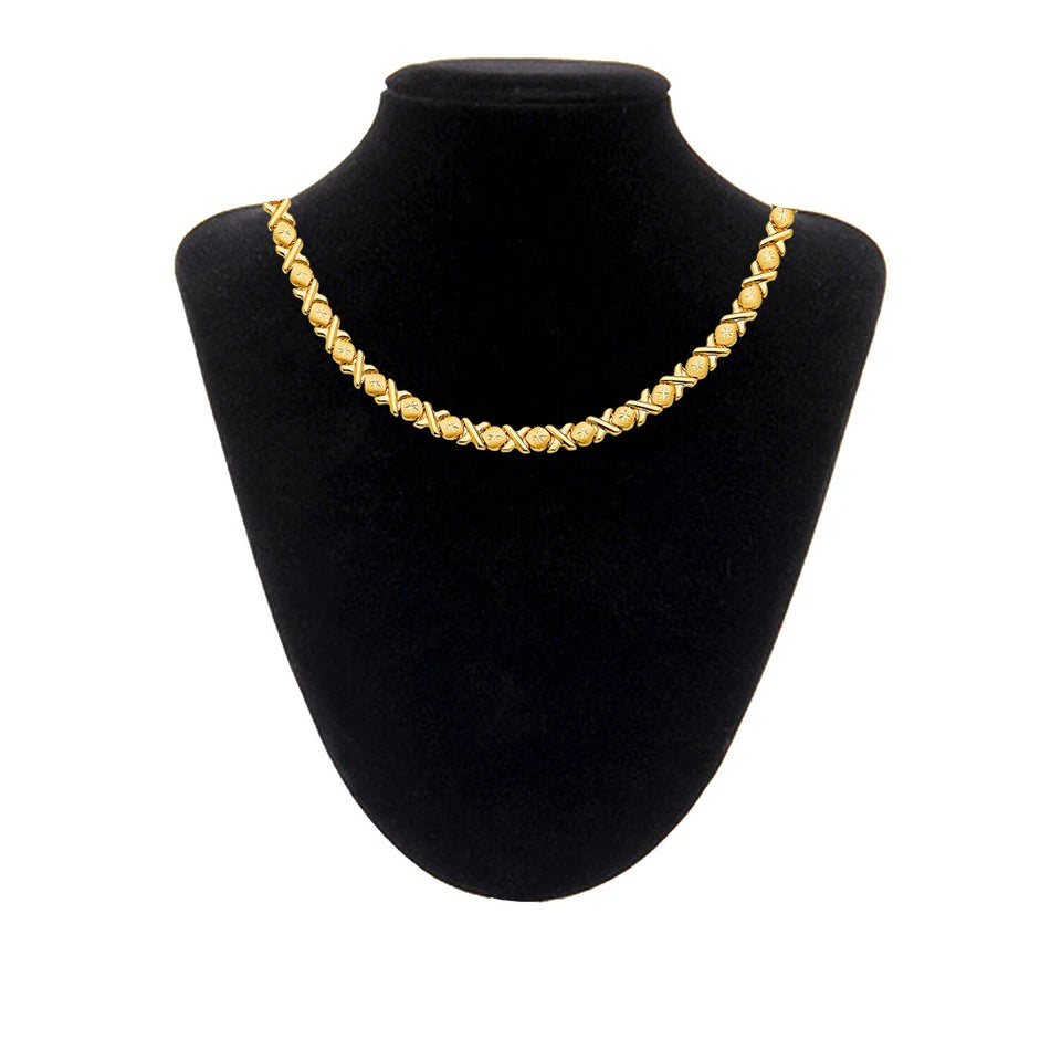 Gold necklace on a black mannequin bust against a white background available on the TX.ORO website.