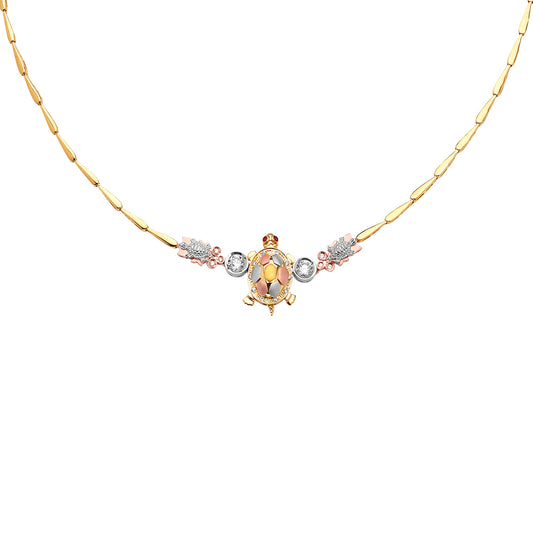 Gold turtle pendant necklace with gemstones on a white background available on the TX.ORO website.