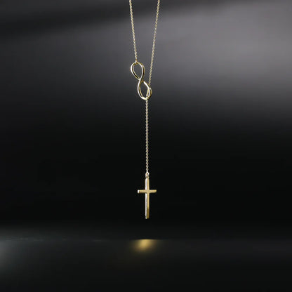 Gold necklace with an infinity symbol and cross pendant on a black background available on the TX.ORO website.