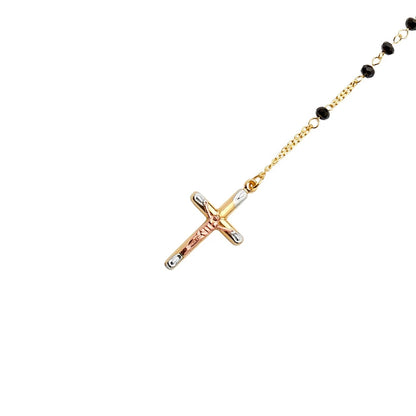 Gold and rose gold cross necklace with black beads on a white background available on the TX.ORO website.