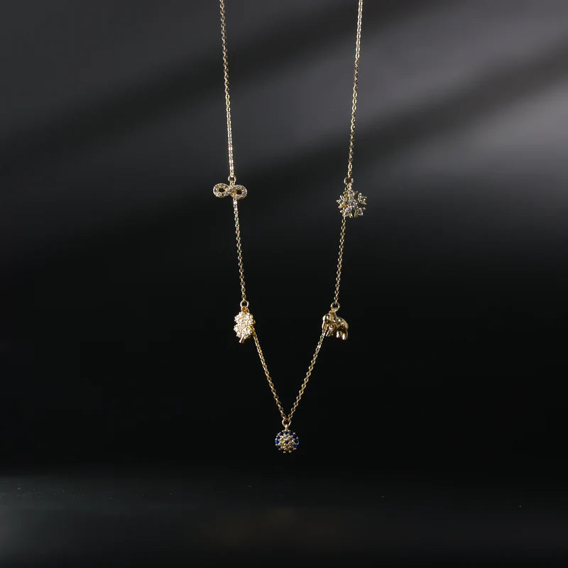 Gold necklace with three pendant drops on a dark background available on the TX.ORO website.