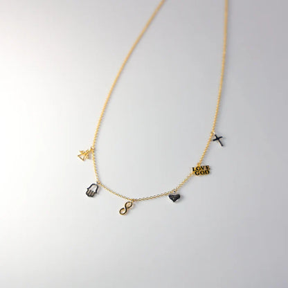 Gold necklace with various charms on a light gray background available on the TX.ORO website.