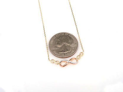Necklace with a coin and infinity symbol pendant on a white background available on the TX.ORO website.