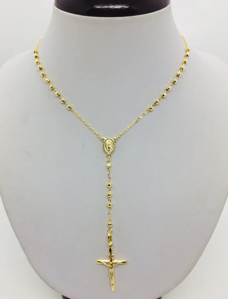 Gold rosary necklace on a mannequin bust available on the TX.ORO website.