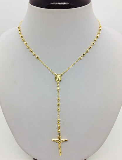 Gold rosary necklace on a mannequin bust available on the TX.ORO website.