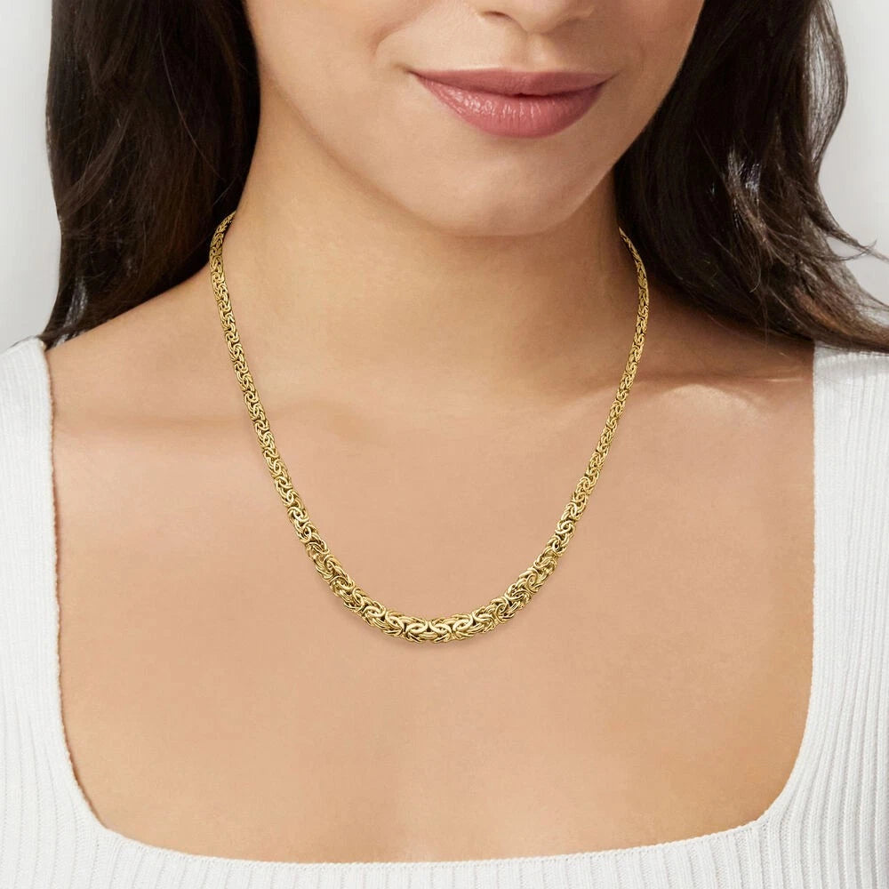 Gold necklace worn by a person on a plain background available on the TX.ORO website.