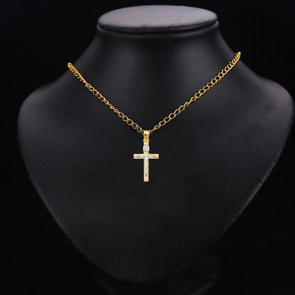 Gold necklace with a cross pendant on a black mannequin bust