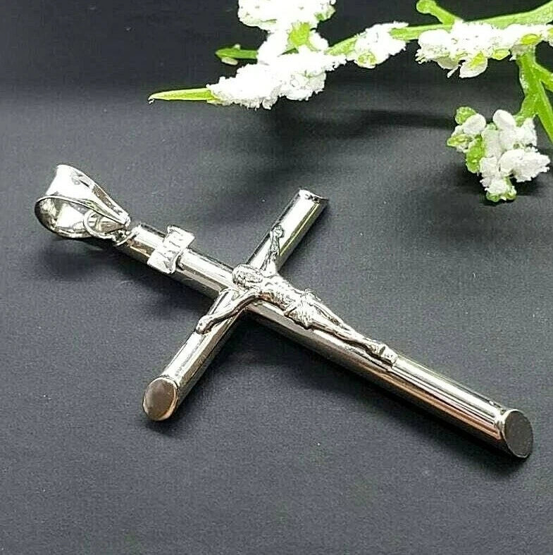 White gold crucifix pendant on a white background available on the TX.ORO website.