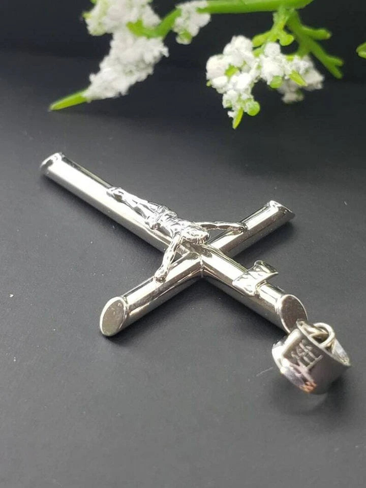 White gold crucifix pendant on a white background available on the TX.ORO website.