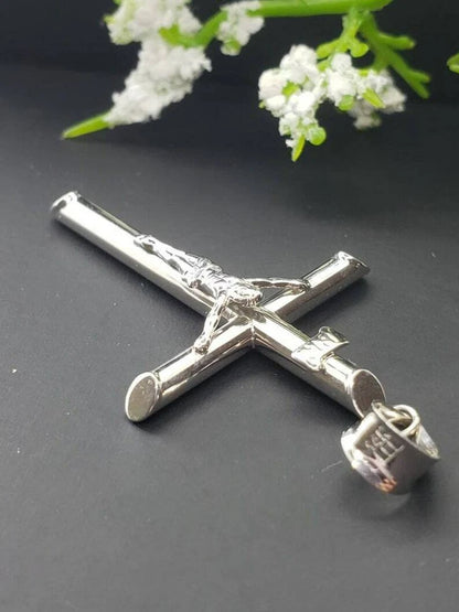 White gold crucifix pendant on a white background available on the TX.ORO website.