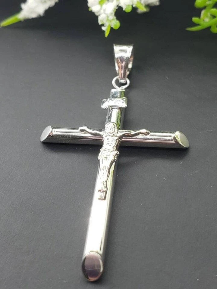 White gold crucifix pendant on a white background available on the TX.ORO website.