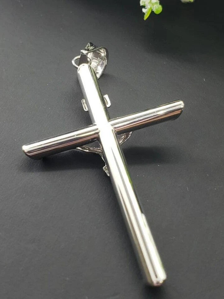 White gold crucifix pendant on a white background available on the TX.ORO website.
