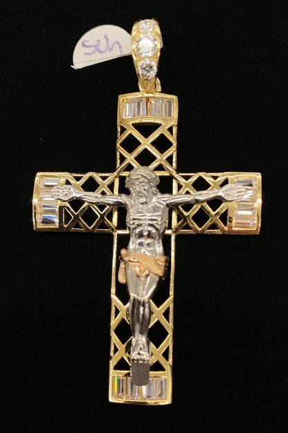 Gold and silver crucifix pendant on a black background