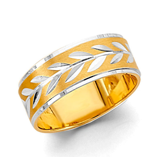 Gold and silver ring with leaf pattern on a white background