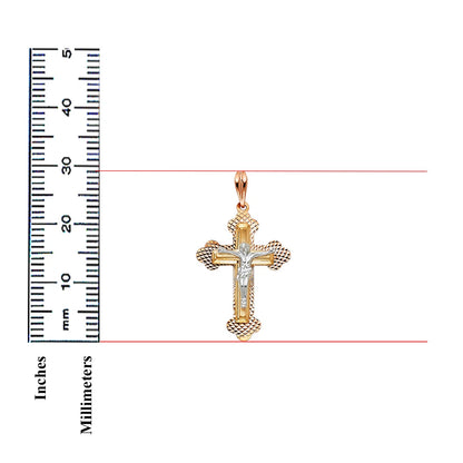 A gold and silver cross pendant with a central silver figure, shown next to a black inch-and-millimeter ruler on a white background.