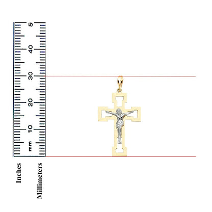A gold and silver crucifix pendant shown on a white background with a black inch-and-millimeter ruler on the left for scale.