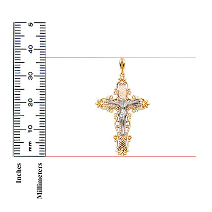 A gold and silver cross pendant with a detailed crucifix design, shown next to a black ruler with inch and millimeter markings to indicate its size on a white background.